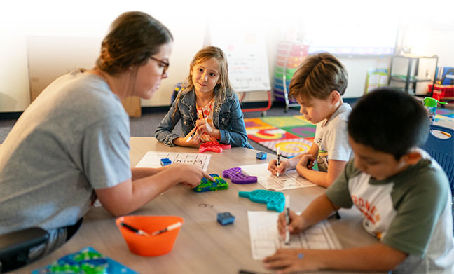 Teacher with students in a classroom setting